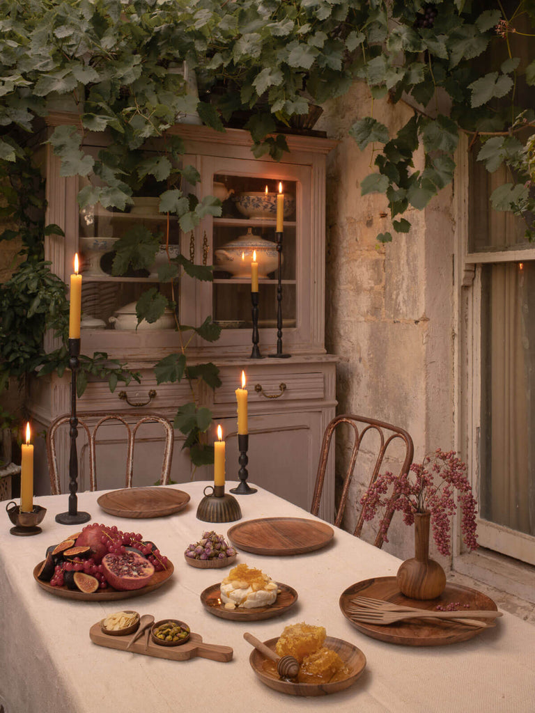 A tablescape in a rustic orangery featuring the Eliot candleholders