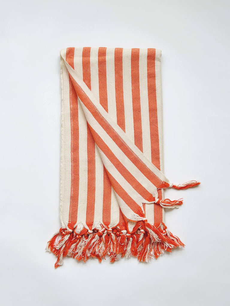 Brighton summer holiday hammam towel with a hot range seaside stripe and fringe, revealing both sides of the lightweight cotton fabric