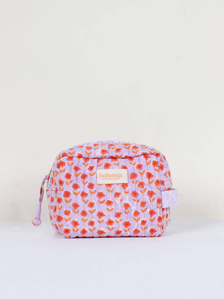 Small hand block print, cotton quilted wash bags with a lilac and orange ditsy floral design