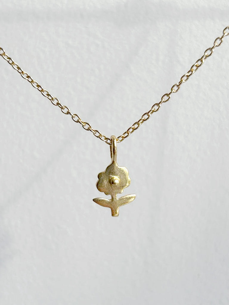 The sweetest Daisy charm hangs from a fine gold chain from the Bloom jewellery collection by Bohemia Design.
