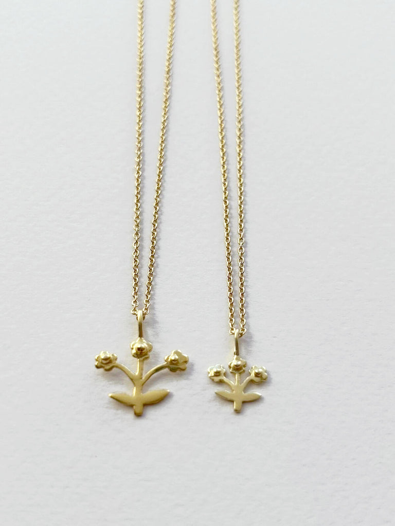 Small and tiny gold posie necklaces side by side
