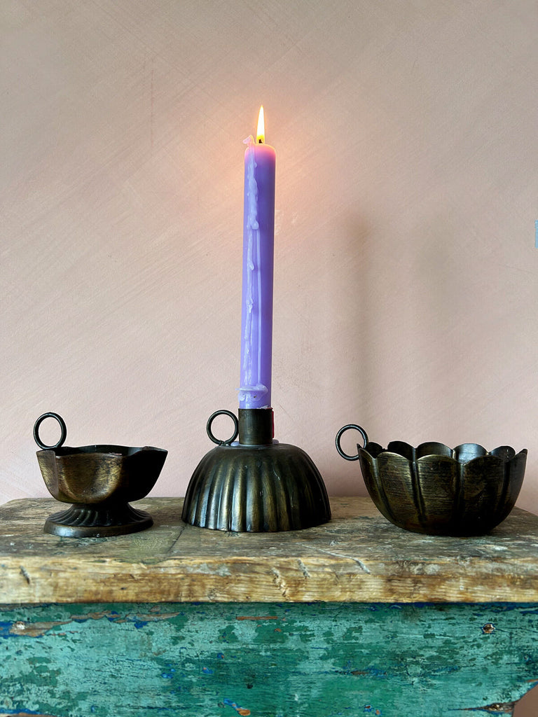 Set of three metal candle holders with petticoat, scallop and frill design, each adorned with a finger hold