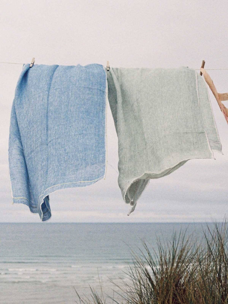 Linen Scarf, Indigo and Lemon hanging on a washing line by the sea