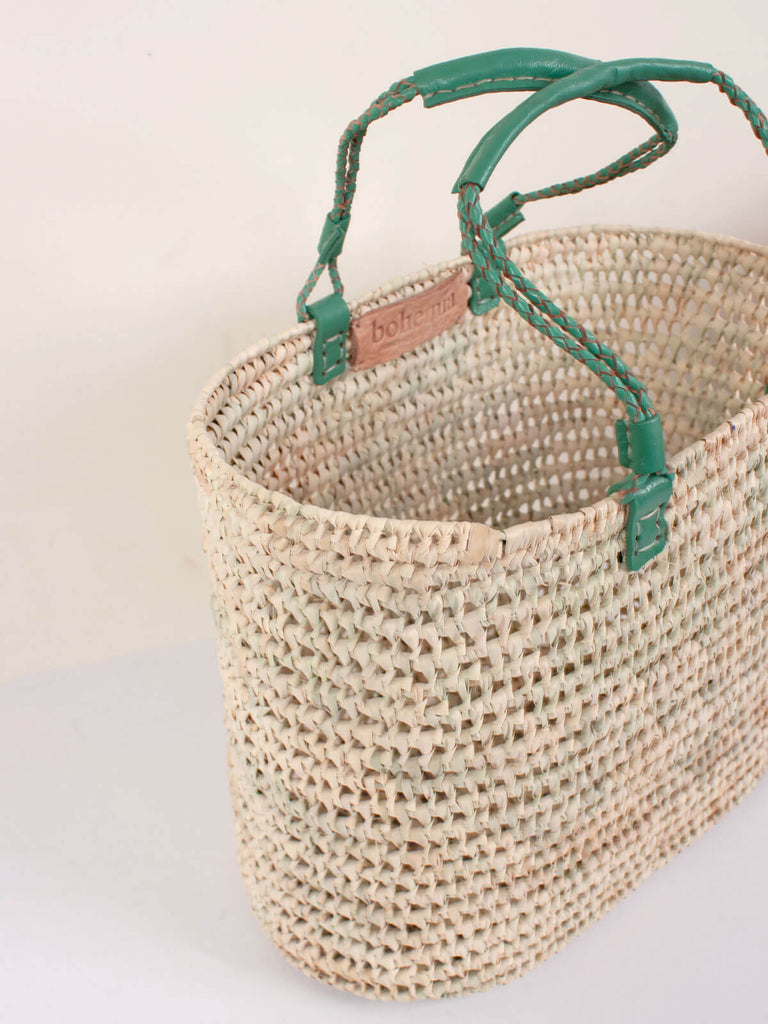 View showing the rounded rectangular shape of the pleated leather handle basket in sage