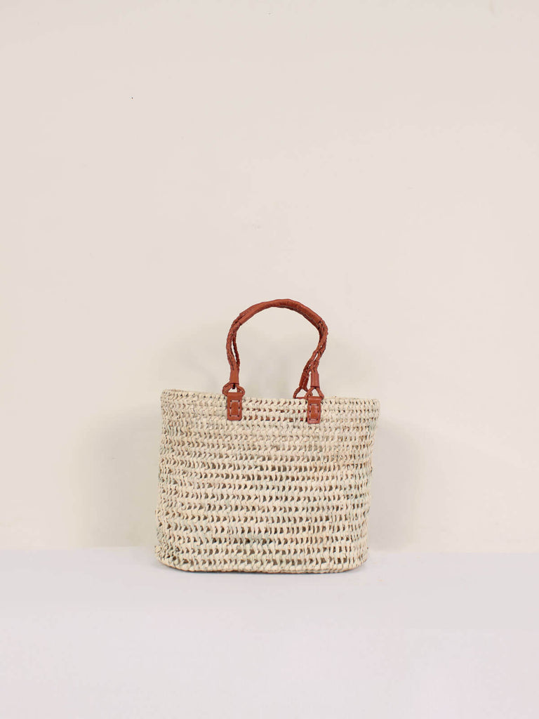 Small open weave natural basket with terracotta pleated leather handles