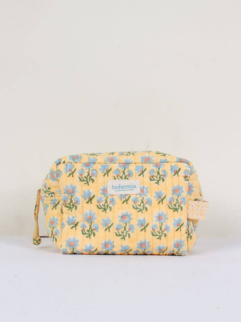 Posie hand block printed, quilted cotton washbag with pastel yellow, blue and green floral pattern