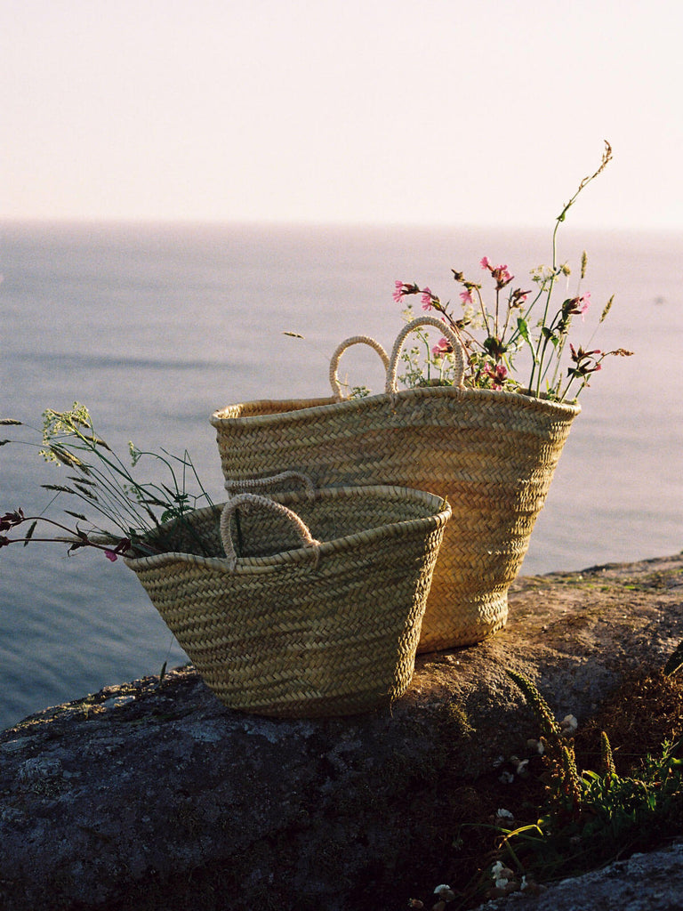Natural woven market baskets filled with wildflowers