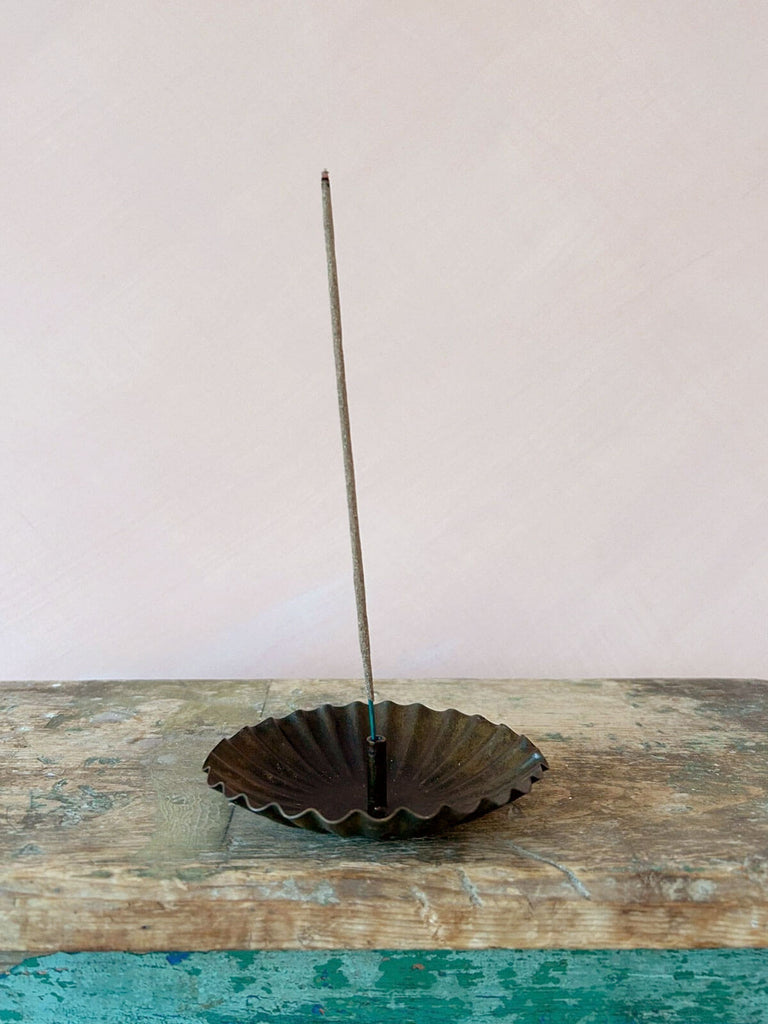 Sol incense holder on an antique wood table