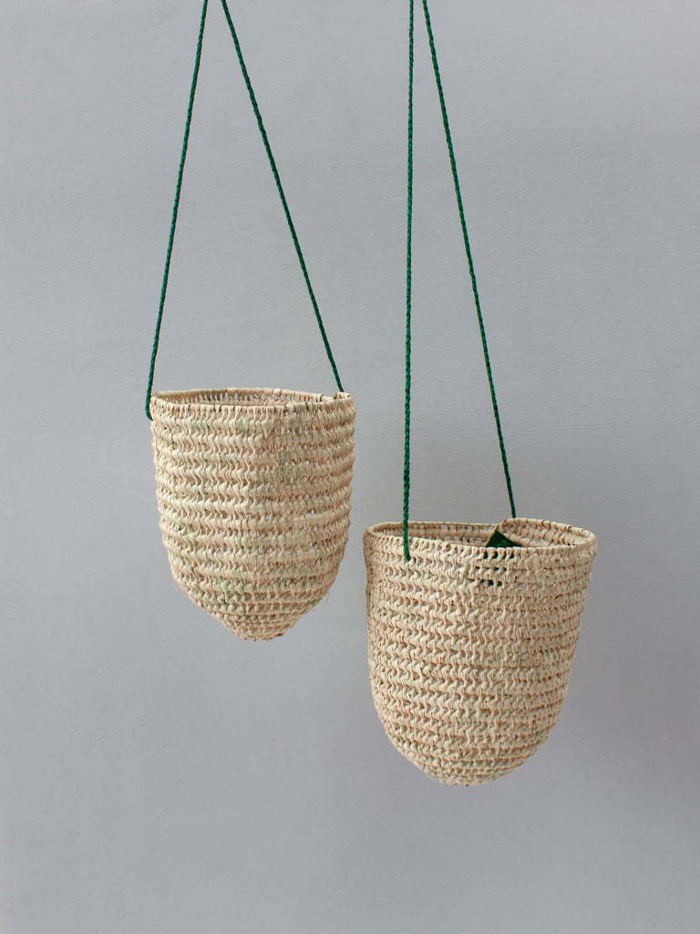 Pair of natural hand woven open weave indoor hanging planters with finely braided green leather 