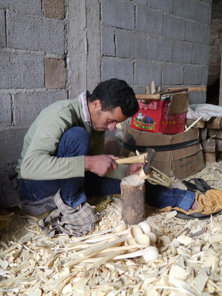 A lemon wood spoon being handmade by a skilled artisan in Morocco.