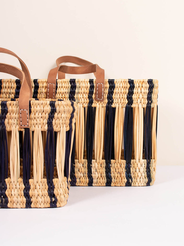 Set of two decorative woven reed basket bags with indigo stripe