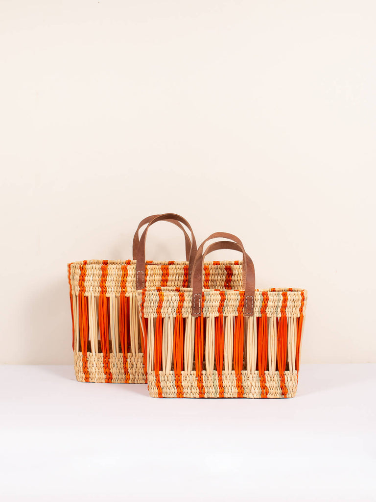 Small and medium decorative reed woven basket bags with orange stripe design and leather handles