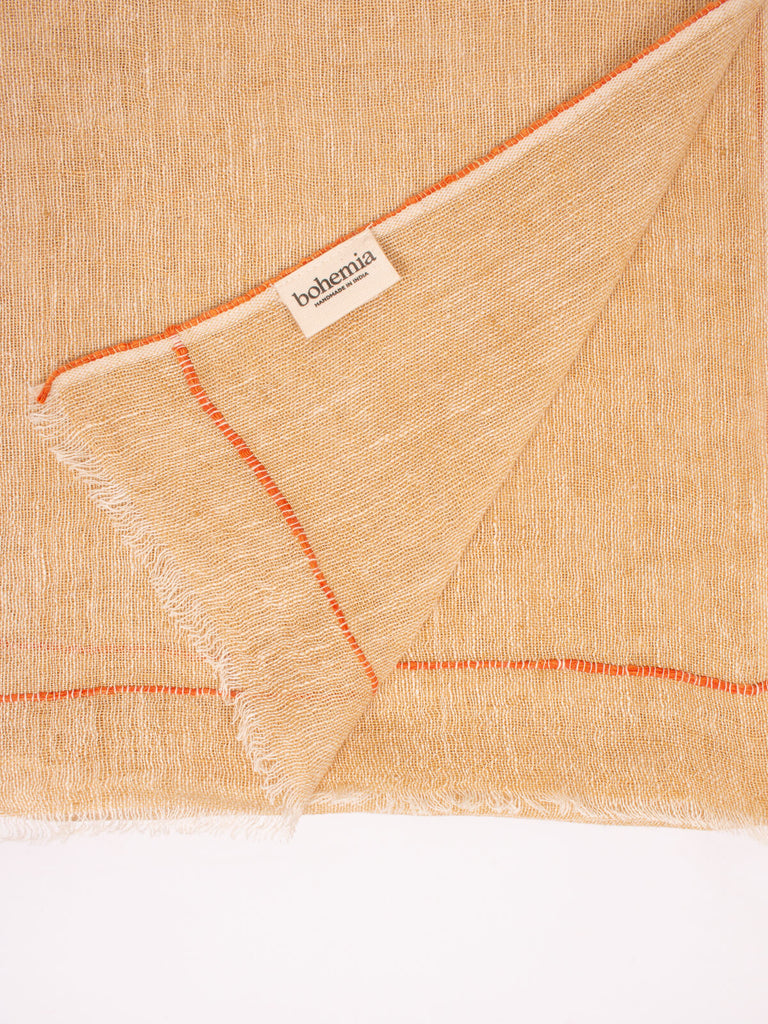 Close up of the mustard linen scarf with orange detail