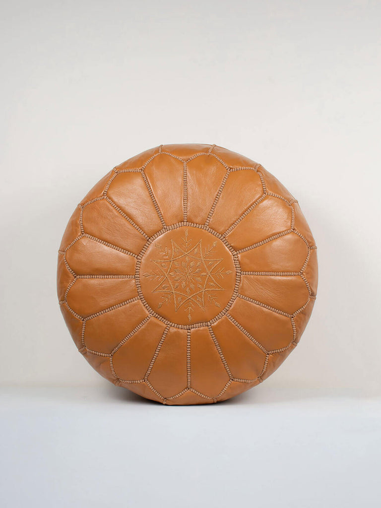 Ochre coloured Moroccan leather pouffe with an embroidered top.