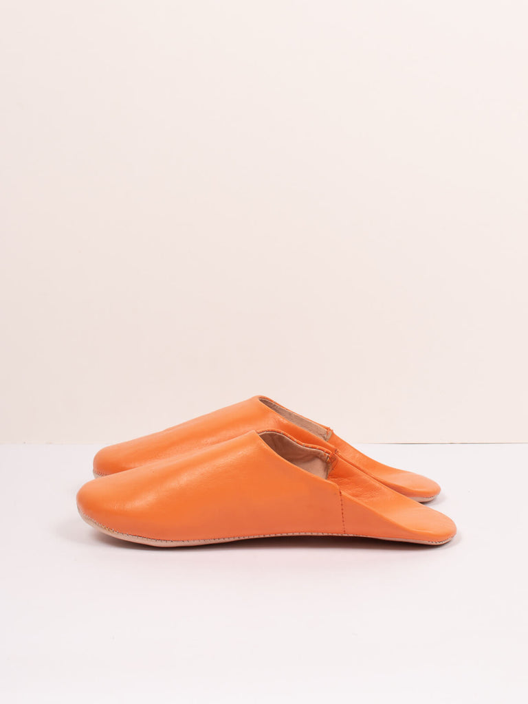Side view of  pair of Moroccan Babouche Basic Slippers in Clementine