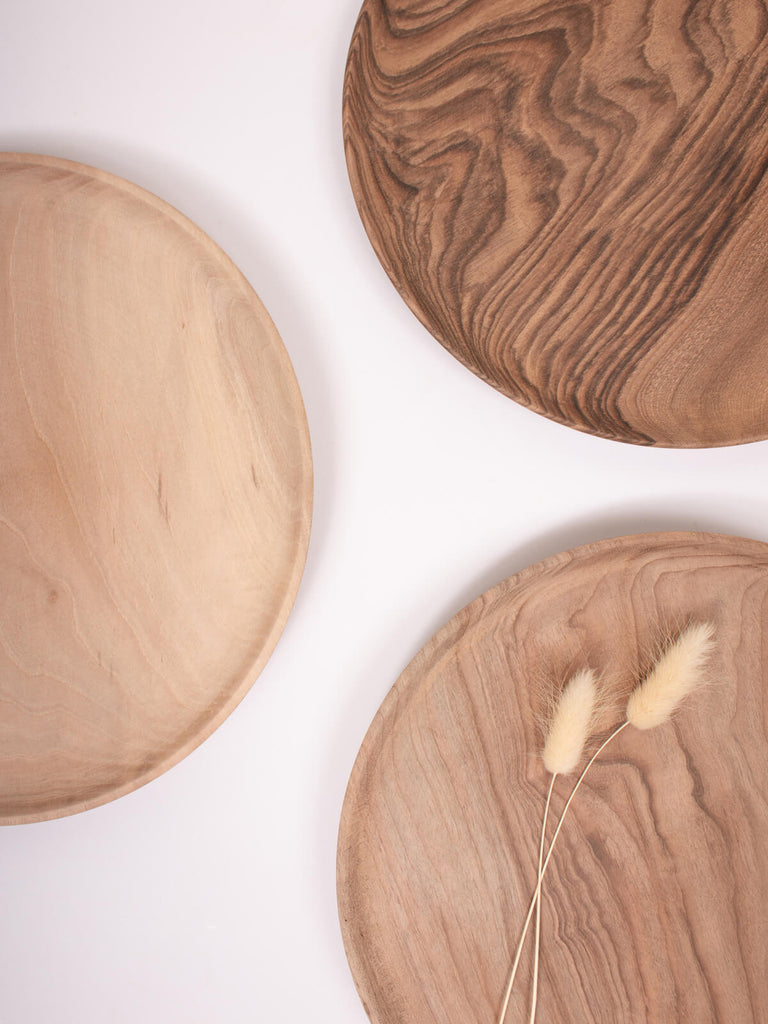 A group of three Walnut Wood Plates showing variation in natural grain.