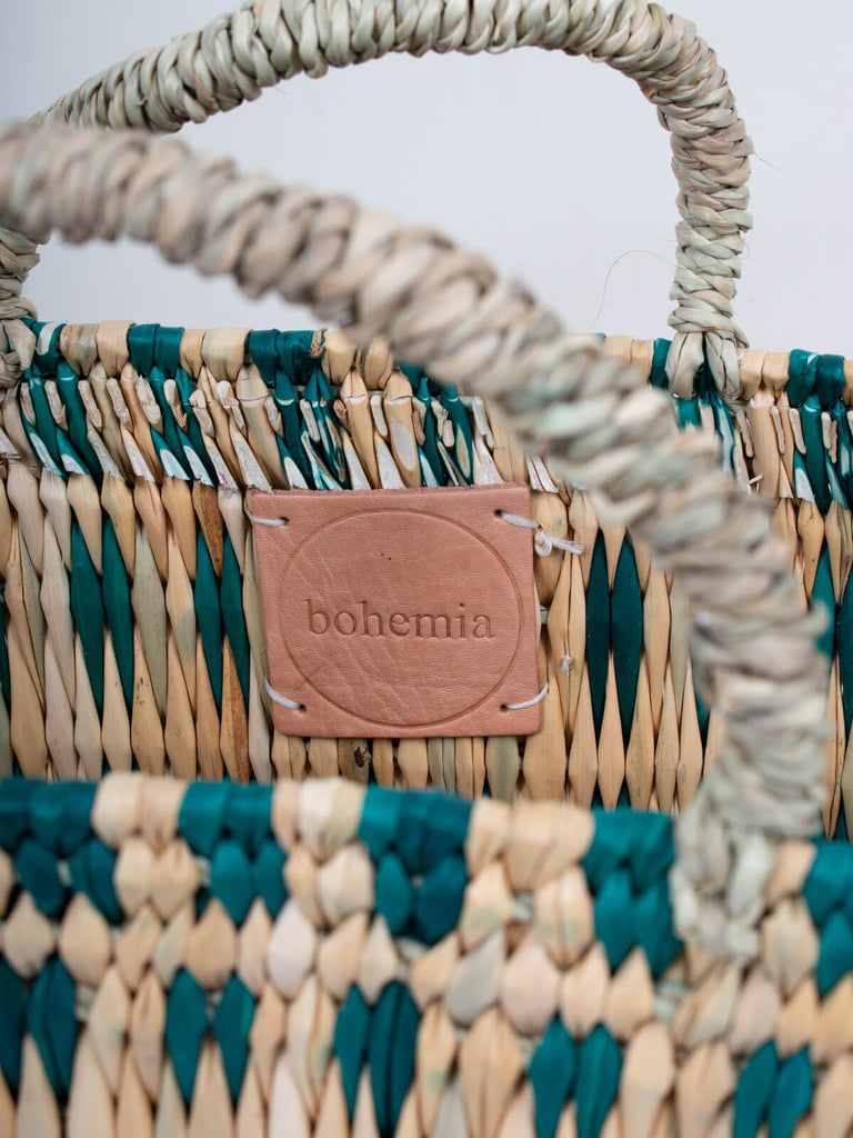 Leather label inside the green woven reed basket bag by Bohemia Design