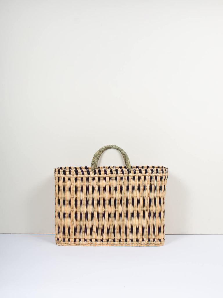 Large natural woven reed basket bag with short handles and skillfully weaved indigo pattern by Bohemia Design