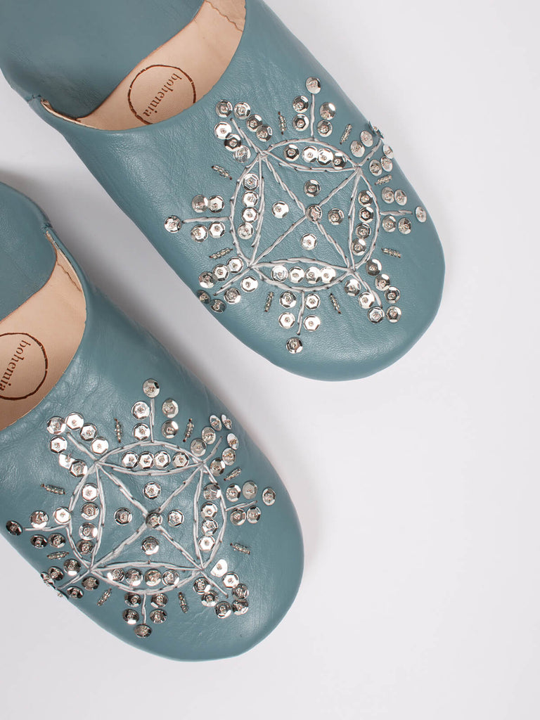 A pair of grey leather Moroccan babouche slippers with a silver sequin design