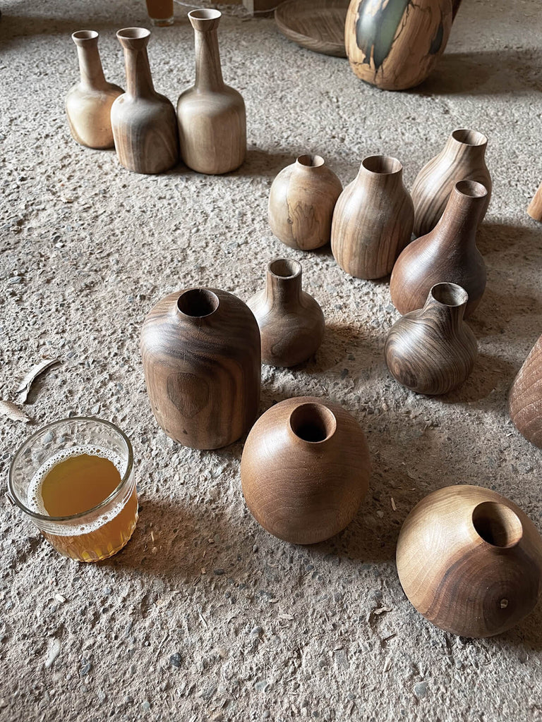 Group of mini wood vases by Bohemia Design in the Moroccan workshop with mint tea