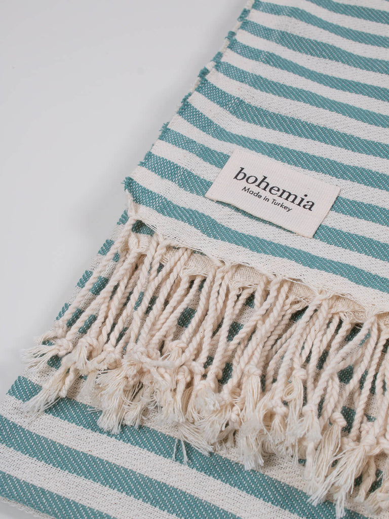 Striped Sorrento Hammam Towel in grey green stripe by Bohemia Design with natural tassles
