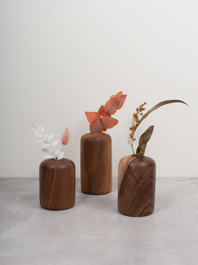 Three walnut wood mini vases by Bohemia Design with dried flower stems