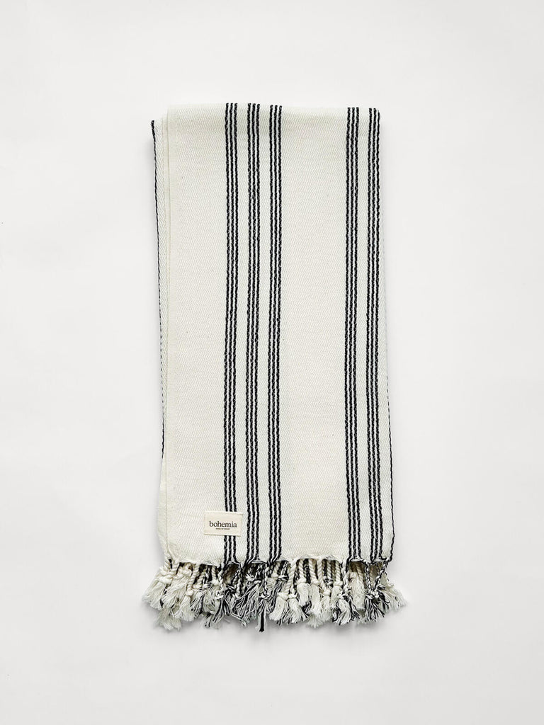 Beautifully tactile Ankara cotton hammam towel with a ticking stripe in charcoal black by Bohemia Design