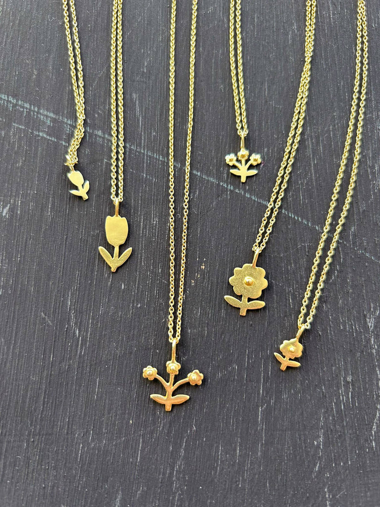 Handmade Bloom jewellery collection with delicate gold floral necklaces. 