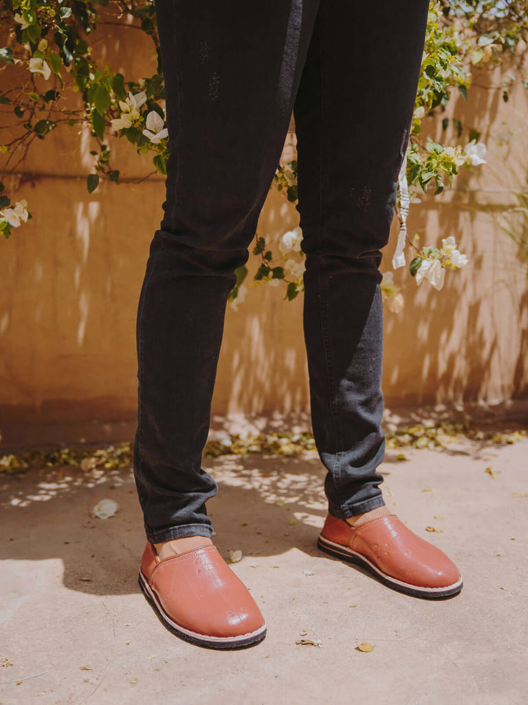 Berber babouche slippers in terracotta leather worn by model in dark skinny jeans