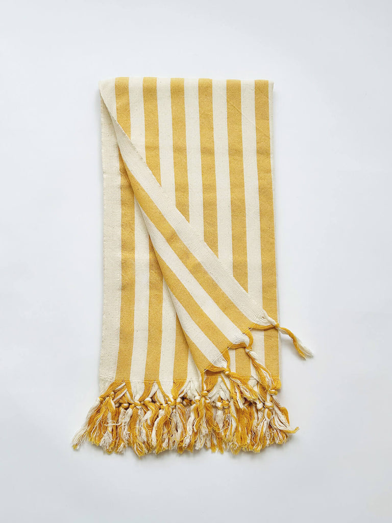 Brighton Stripe hammam towel with a classic mustard yellow seaside stripe and fringe