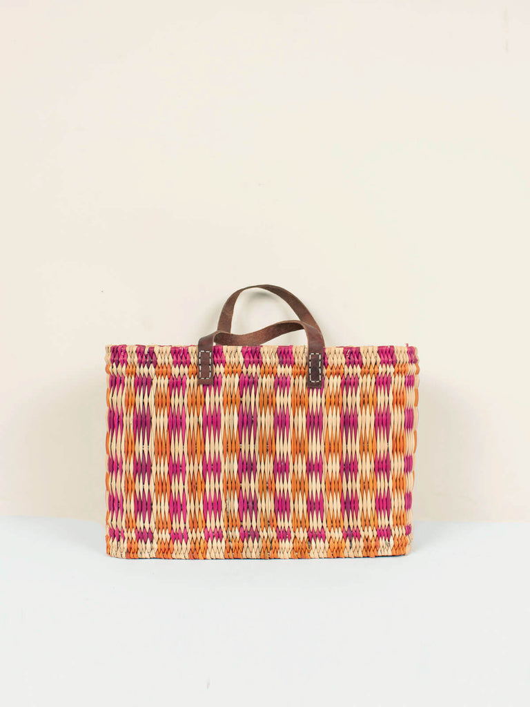 Medium size rectangular, pink and orange chequered woven basket bag with leather handles