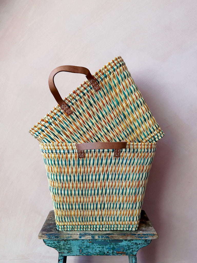 Two colourful teal and orange woven wicker reed shopper baskets with sturdy tall rectangular shape