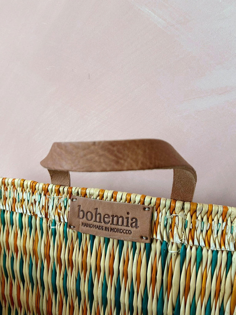 Strong supple leather handles on the teal and orange woven wicker reed shopper basket by Bohemia