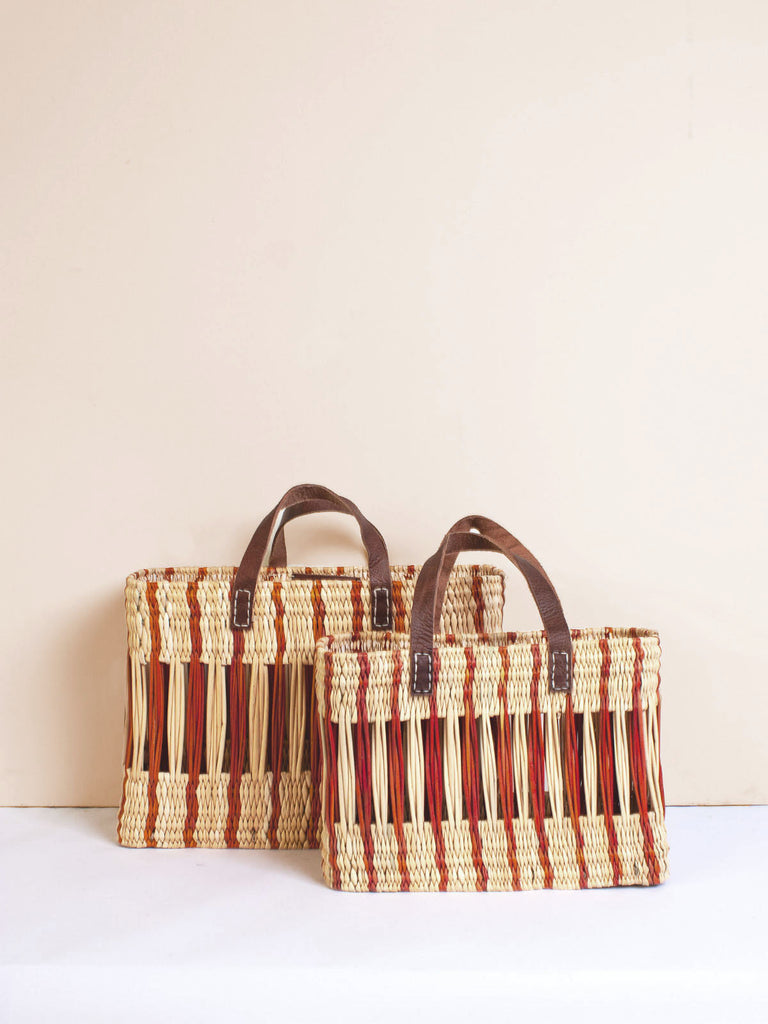 Two decorative rectangular reed baskets with amber stripes and intricate woven design