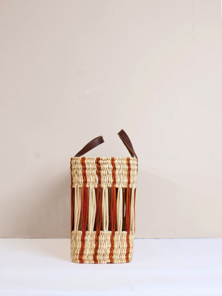 Sturdy rectangular reed basket with amber stripe design and short leather handles