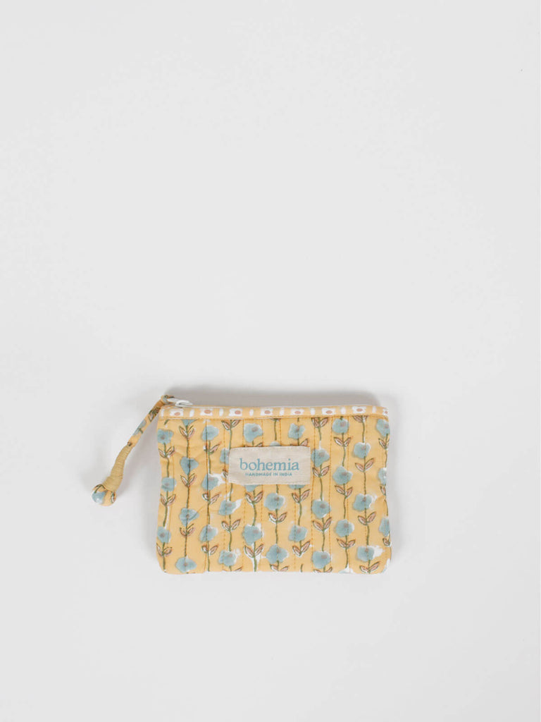 Small quilted cotton zip pouch hand block printed in Jaipur, with a buttermilk yellow ditsy floral print 