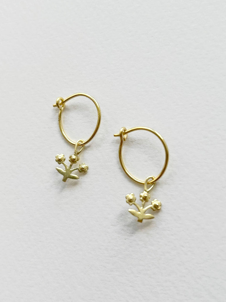 Minimalist gold hoop earrings with delicate flower design