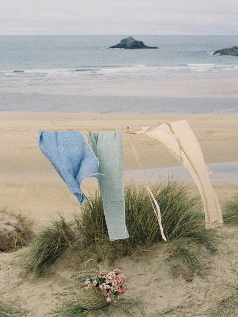 Linen Scarf, Indigo and Lemon hanging on a washing line by the sea