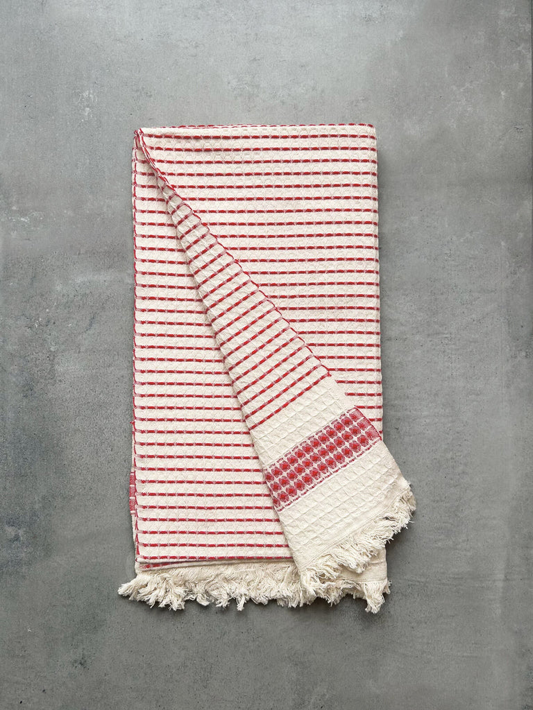 Milos Check Hammam Towel with a waffle textured weave and a terracotta stripe, revealing soft cotton fabric on both sides | Bohemia Design