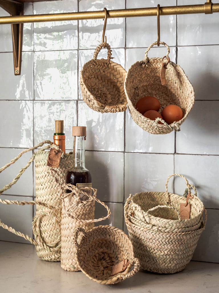 Small handwoven natural storage baskets in a kitchen
