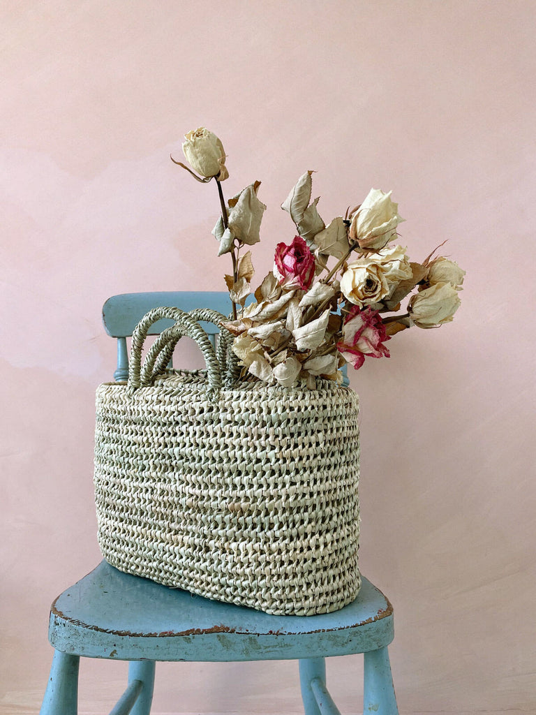 Oval shaped open weave nesting baskets with short handles filled with dried flowers