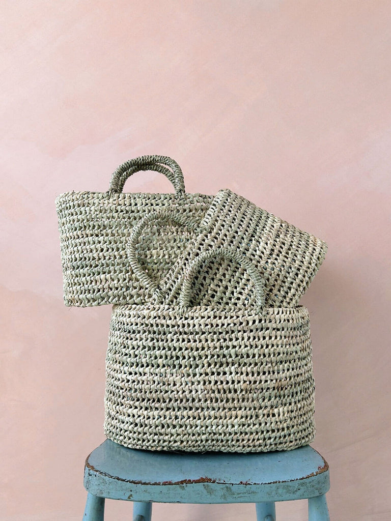 Set of three open weave nesting storage baskets with short handles and open weave design by Bohemia