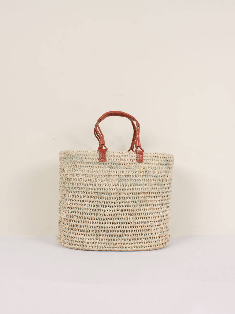 Large open weave natural basket with terracotta pleated leather handles