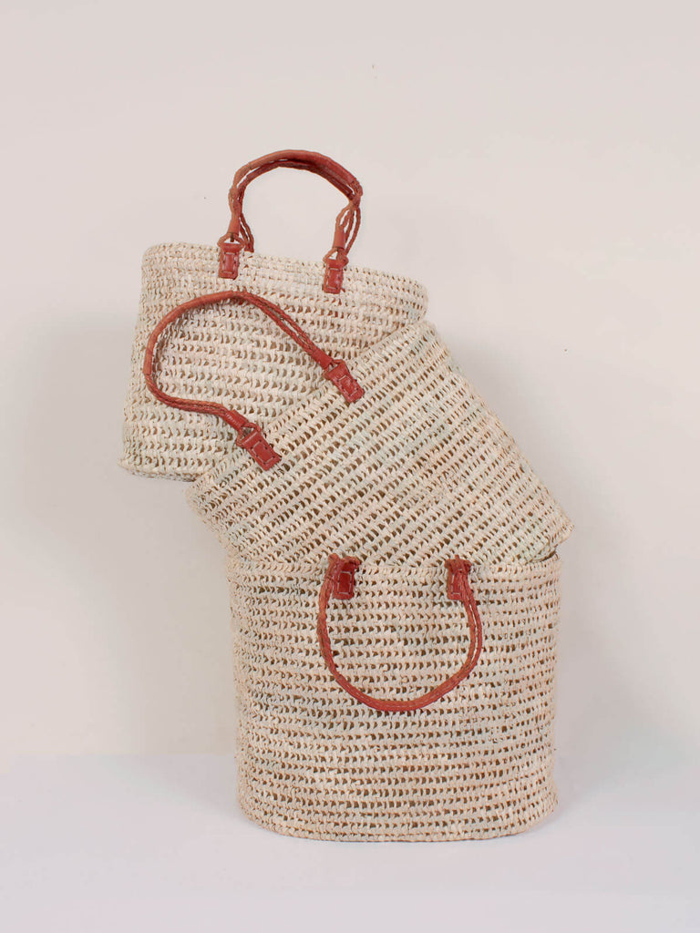 Three different sized pleated leather handle baskets stacked together