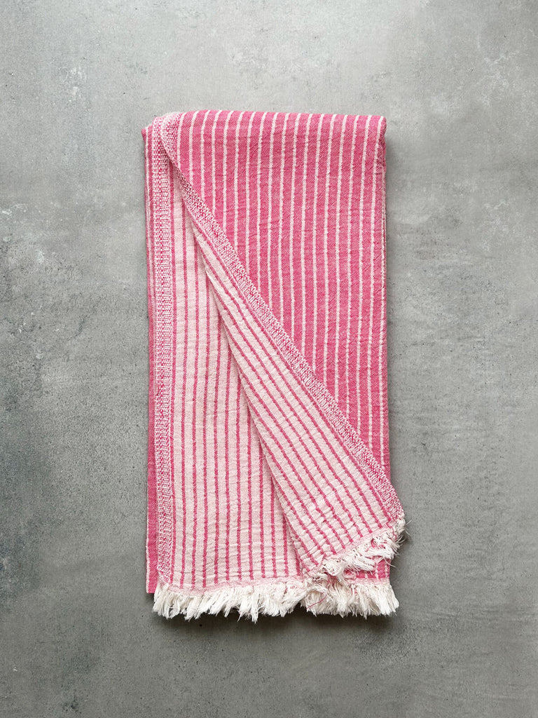 Turkish cotton hammam towel in flamingo pink stripe, revealing a soft textured pattern on both sides | Bohemia Design