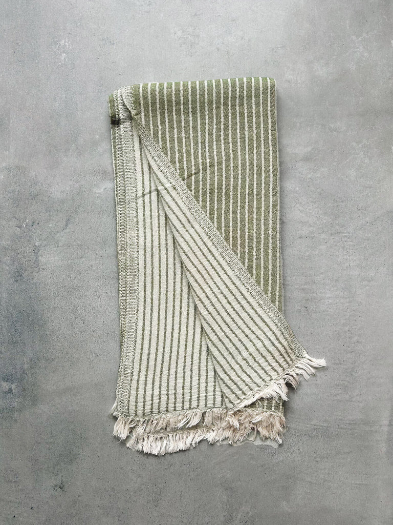 Turkish cotton hammam towel in olive green, revealing a soft textured striped pattern on both sides | Bohemia Design