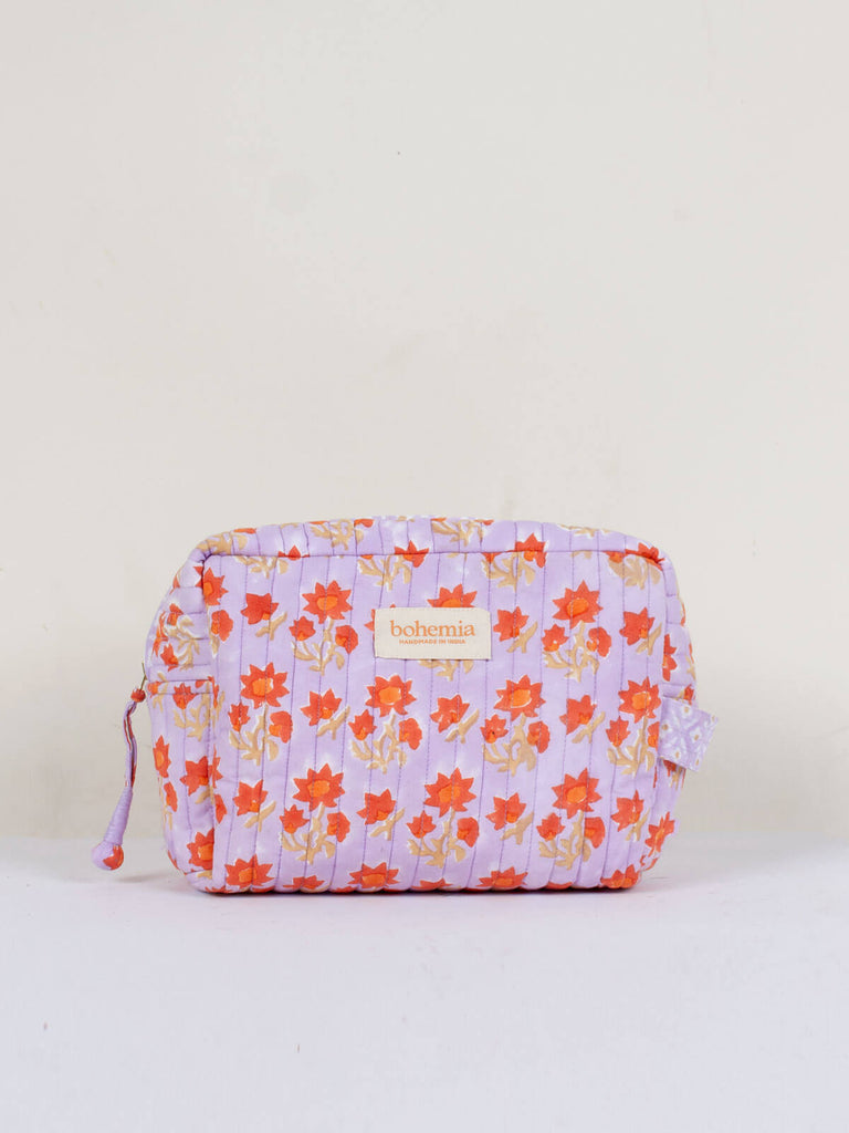 Medium hand block print, cotton quilted wash bags with a lilac and orange floral design