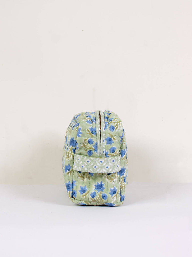Side showing zip and handle of a Posie block printed quilted washbag with sage green and blue floral pattern