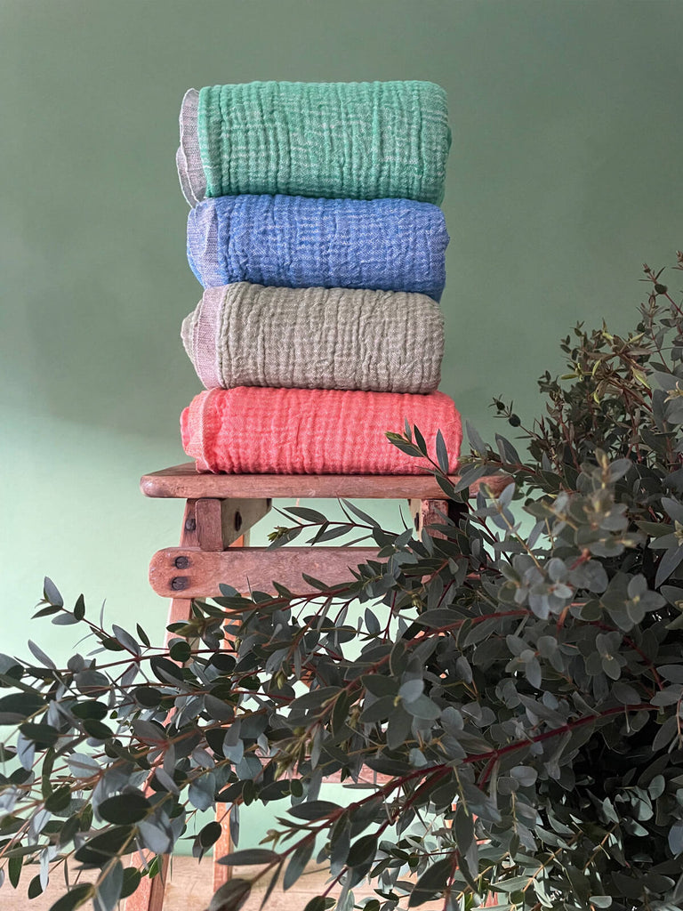 A stack of hammam towels in various colours and textures by Bohemia Design