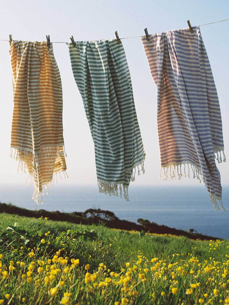 Striped Sorrento Hammam Towels hanging on a washing line by Bohemia Design